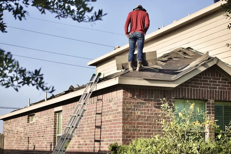 Professional roofer working on a residential roof in Westbranch